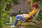 Woman working on laptop in garden