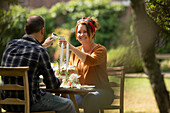 Happy couple bonding at sunny garden table