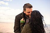 Affectionate couple kissing on beach