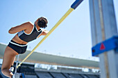 Female track and field athlete high jumping