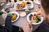Couple enjoying fresh seafood on patio table