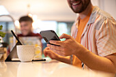 Young man using smart phone at home