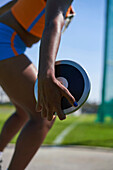 Female track and field athlete throwing discus