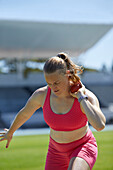 Female track and field athlete throwing shot put