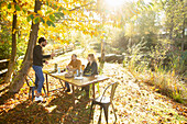 Business people meeting at table in sunny autumn park
