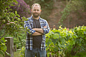 Confident man with beard in garden
