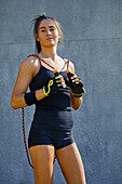 Confident tough teenage athlete with jump rope
