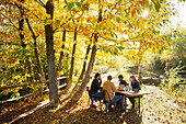 Business people meeting at table in sunny autumn park