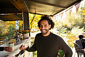 Happy male customer ordering coffee at food cart in park