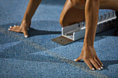 Female track and field athlete at starting block
