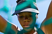Determined female track and field athlete in visor