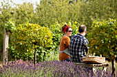 Couple taking a break from gardening in sunny summer garden