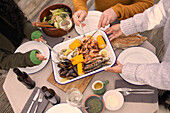 Friends enjoying fresh seafood at patio table