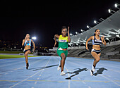Female athlete running in competition on track