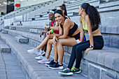 Female athletes taking a break on stadium steps