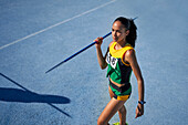 Female athlete preparing to throw javelin on track