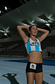 Happy track and field runner finishing race on sports track