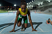 Determined track and field runner at starting block