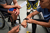 Male amputee and wheelchair athletes in locker room