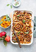 Sausage coils with apples, pumpkin seeds, and sage, served with pumpkin puree
