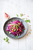 Salad with red pointed cabbage, grapefruit, walnut kernel oil and pecan nuts (vegan)