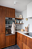 Kitchen with simple wooden fronts and artistic ornaments