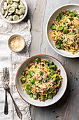 Spaghetti Carbonara with broad beans, bacon and grated parmesan