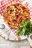 Pizza mit Peperoni und Antipasti