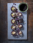 Vegetarian california rolls with black rice, avocado and sesam seeds