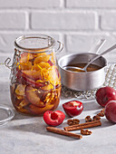 Pickled red plums with nuts and oranges