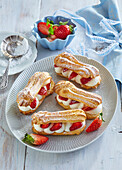 Eclairs with strawberries and cream