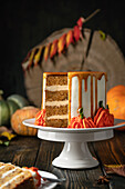 Pumpkin spice cutaway cake on wooden background