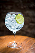 Classic gin and tonic with lime wheel