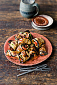 Oriental aubergine rolls with hummus and tomato filling