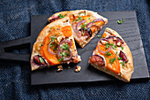 Vegan pizza with pumpkin, figs, onions and wild mushrooms
