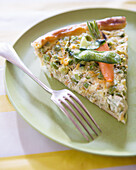 A slice of pea and carrot quiche