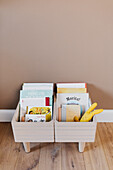 Boxes of books on wooden floor in nursery