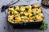 Vegan potato and Brussels sprouts bake, gratinated with almond cheese