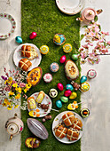 Easter table with hot cross buns, sweets and tea