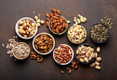 Assorted nuts and various seeds in bowls