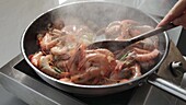 Frying prawns in a pan