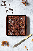 A paper baking tray of chocolate brownies cut into squares