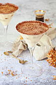 Tiramisu presented in martini glasses and dusted with cocoa powder and grated chocolate
