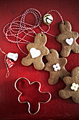 Gingerbread figures with decorative elements on a red background