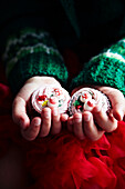 Two Christmas cupcakes in child's hands