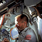 Astronaut Walter Cunningham performing flight tasks