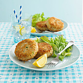 Plate of two fishcakes and salad