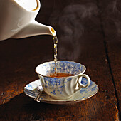 Pouring freshly brewed black tea