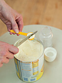 Woman measuring infant formula powder