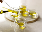 Extra virgin olive oil being poured into a glass